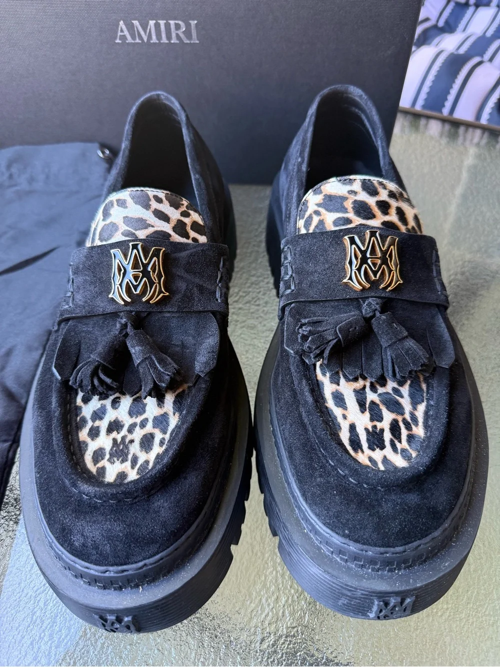 AMIRI Black Suede Tassel Loafers with Leopard Accent and Gold Crest